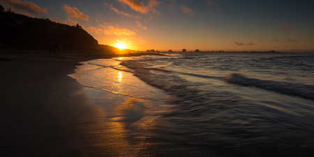 Beautiful Sunset at a Beach. Long exposure, motion blur on the wavesの写真素材