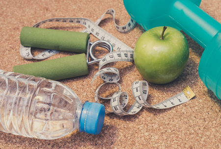 Lay Flat - Dumbbell, Fresh Apple, Measuring Tape, Mineral Water, Hand Grip - Fitness Conceptの写真素材