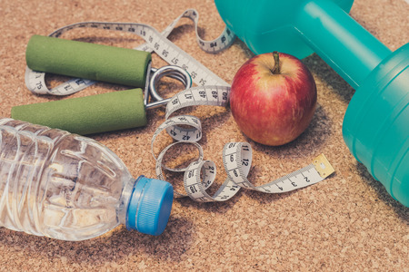Lay Flat - Dumbbell, Fresh Apple, Measuring Tape, Mineral Water, Hand Grip - Fitness Conceptの写真素材