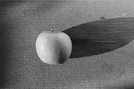 Green Apple on red background,. Harsh shadowの写真素材