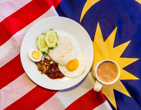 Malaysian Breakfast - Nasi Lemak and Teh Tarik on Malaysia Flag. Both dishes are unofficially the national breakfast dish of Malaysiaの写真素材