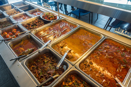 Buffet of Indian dishes - chicken, mutton, curry, vegetarian, spicy and non spicy - at a restaurant.の写真素材