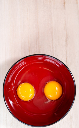 Egg Yolk in a Red Rice Bowl, Shallow depth of fieldの写真素材