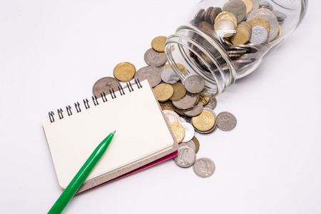 Jar of Malaysia Coins, Blank notepad for text, White Background. Financial Concept.Shallow Depth of fieldの写真素材