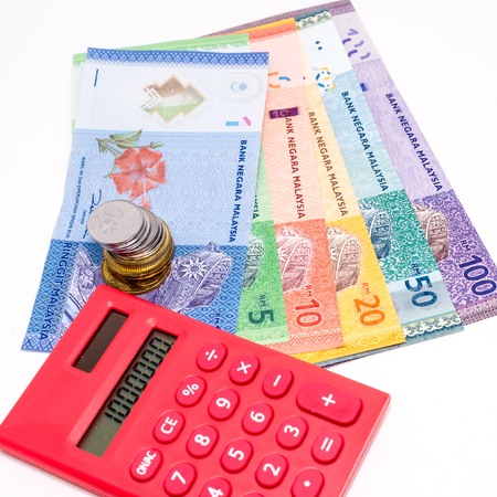 Malaysia Ringgit banknotes,  red calculateor. White background. FOREX Concept. Shallow Depth of...