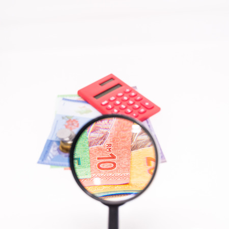 Magnifying the Ringgit Notes. Financial Concept. White Background. Shallow Depth of fieldの写真素材