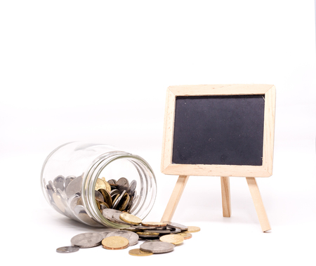 Jar of Coins, Blank Blackboard for text. White Background Isolated. Savings concept.Shallow Depth of fieldの写真素材