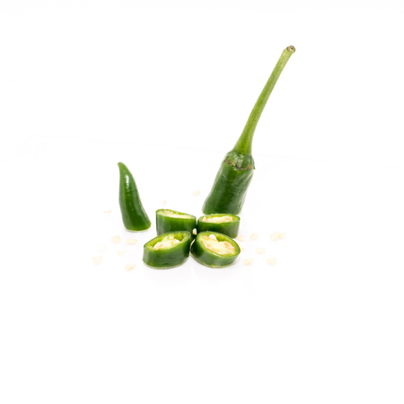 Isolated White Background - Green Chilis. Shallow depth of field.