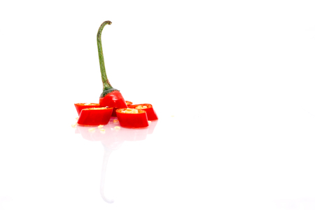 Isolated White Background -  Red Chilis. Reflected. Flower pattern. Shallow depth of fieldの写真素材
