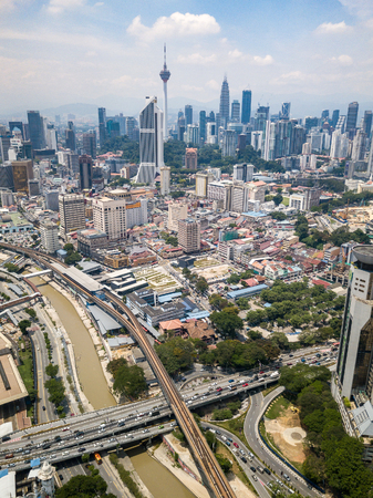 Aerial Photo - Kuala Lumpur City and Blue Sky. An elevated track of the Light Rail Transit (LRT) alongside the mucky Klang River.のeditorial素材