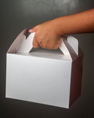 Kid holding a blank white cake box.の写真素材