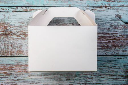 White Cardboard Fast Food Box, Packaging For Lunch. On wooden table. Ready For Your business design.
