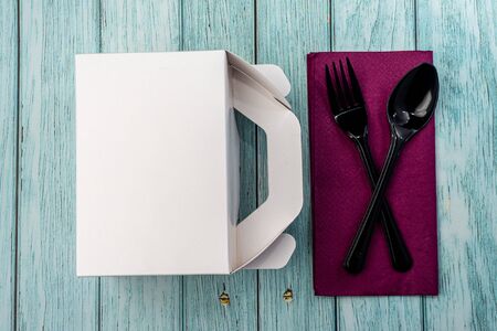 White Cardboard Fast Food Box, Packaging For Lunch on wooden table. with utensils on purple serviette. Ready For Your business design.の写真素材