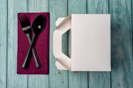 White Cardboard Fast Food Box, Packaging For Lunch on wooden table. with utensils on purple serviette. Ready For Your business design.の写真素材