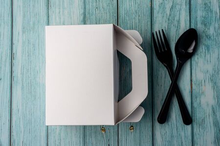 White Cardboard Fast Food Box, Packaging For Lunch on wooden table. with utensils. Ready For Your business design.の写真素材