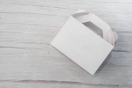 White Cardboard Fast Food Box, Packaging For Lunch on wooden table. Ready For Your business design.の写真素材