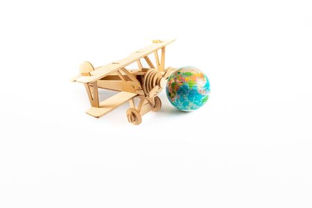 Model Aeroplane and World Globe. Travel Concept. Isolated on white backgroundの写真素材