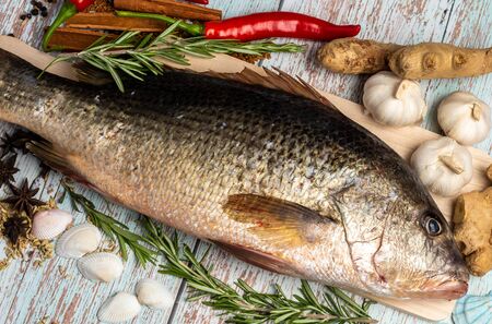 Fresh Fatty Fish on wooden table