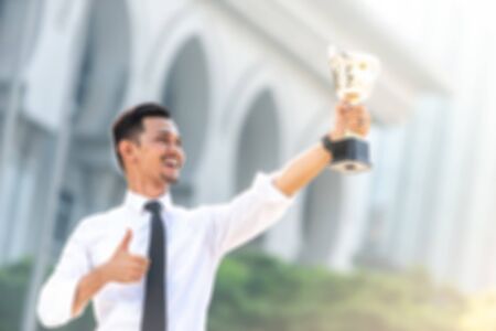 Malay Businessman wins a trophy. Top employee conceptの写真素材