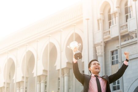 Businessman wins a trophy. Top salesperson conceptの写真素材