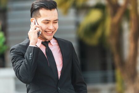Young Malay Business Man talking on his Smartphone.の写真素材