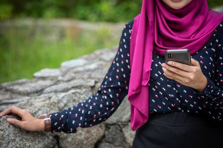 Muslim Woman with her smartphone. Outdoor Settingの写真素材