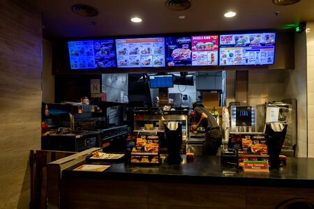 Malaysia, Circa 2019: Ordering counter Burger King restaurant in Kuala Lumpur. Burger King is an American global chain of hamburger fast food restaurants.のeditorial素材