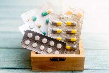 Medicine Pills in a wooden box on  wooden background. Shallow Depth of field.の写真素材