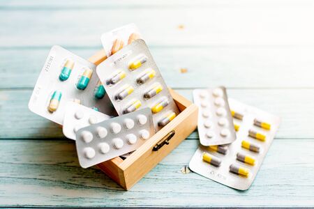 Medicine Pills in a wooden box on  wooden background. Shallow Depth of field.の写真素材