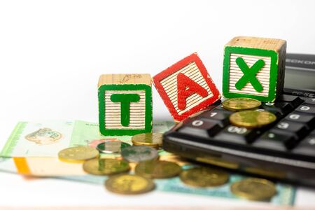 Tax Time concept - Calculator and paper money on white background. Shallow depth of field,. Soft focusの写真素材