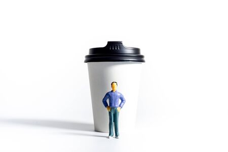 Miniature People and Coffee to-go Cup on white background. Cafe menu concept. Shallow depth of field.の写真素材