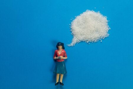 Miniature Models and Sugar talking bubble. Healthy lifestyle concept. Talking about sugar