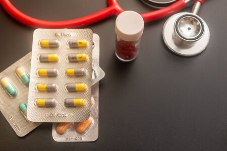 Pills and stethoscope. Healthcare concept. Shallow depth of fieldの写真素材