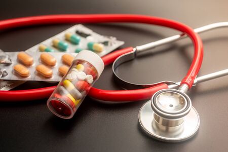 Pills and stethoscope. Healthcare concept. Shallow depth of fieldの写真素材