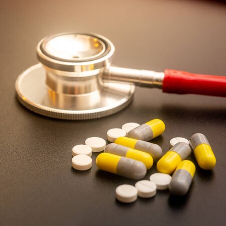 Pills and stethoscope. Healthcare concept. Shallow depth of fieldの写真素材