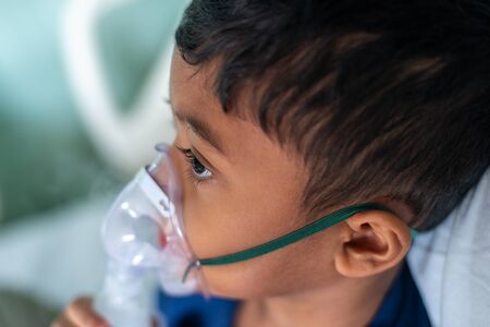 Muslim Boy with his nebuliser. Asthma treatment. Soft focus, shallow depth of fieldの写真素材