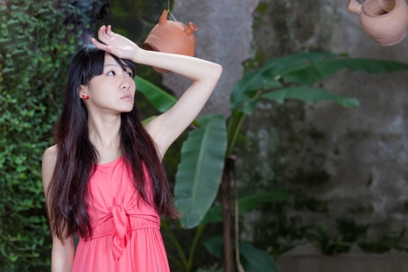 Asian girl by foliageの写真素材