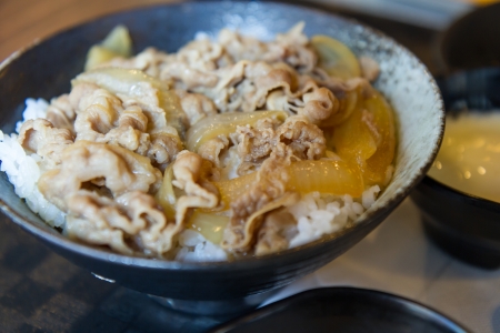 Japanese pork and rice in a black bowlの写真素材