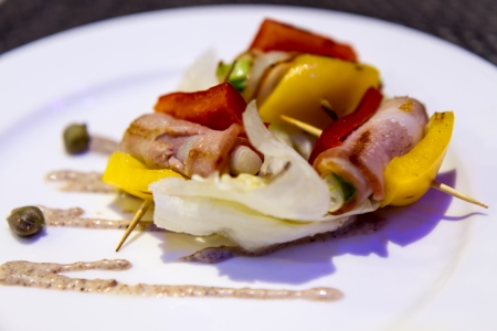 Bacon appetizer on stick with peppers and onionsの写真素材