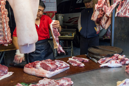 NEW TAIPEI CITY, TAIPEI, TAIWAN. NOVEMBER 2, 2014. Traditional street market in Taiwan with vendors selling fresh meatのeditorial素材
