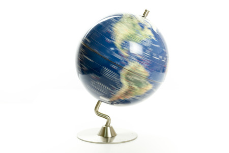 Globe of the world spinning isolated on white backgroundの写真素材