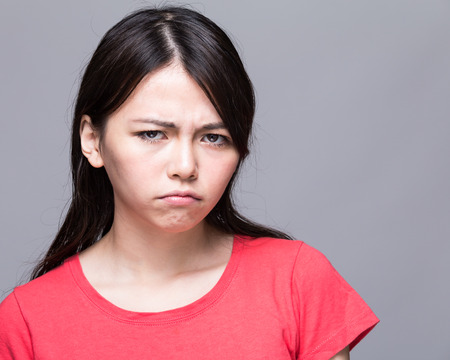 Upset Chinese woman scowlingの写真素材