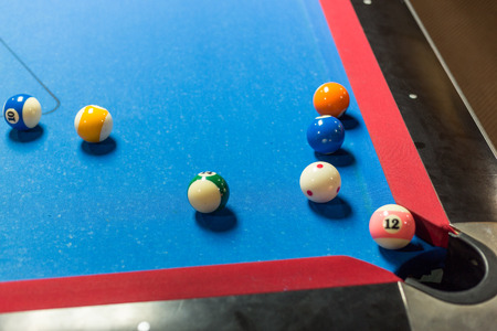 Balls on a pool table with blue felt