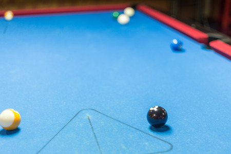 Balls on a pool table with blue felt