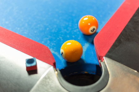 Ball near corner pocket of a pool table