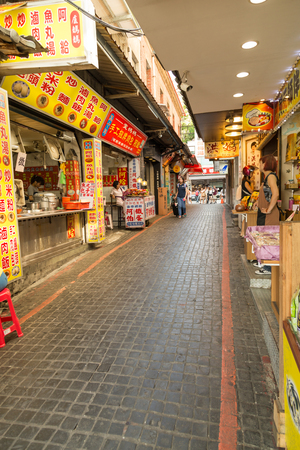 NEW TAIPEI CITY, TAIWAN - SEPTEMBER 11, 2015: Street vendors and shoppers at Danshui shopping areaのeditorial素材