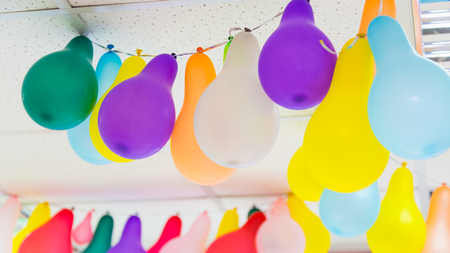 Colorful bunch of balloons hanging from ceilingの写真素材