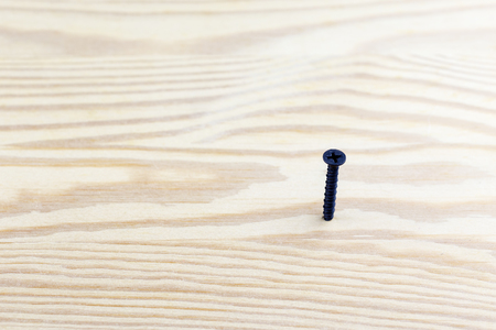 Macro shot of screw in a wooden boardの写真素材