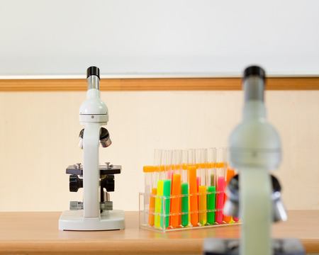 Microscope and bright test tubes in science labの写真素材