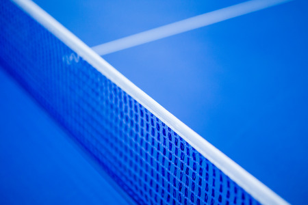 Net on blue ping pong tennis tableの写真素材